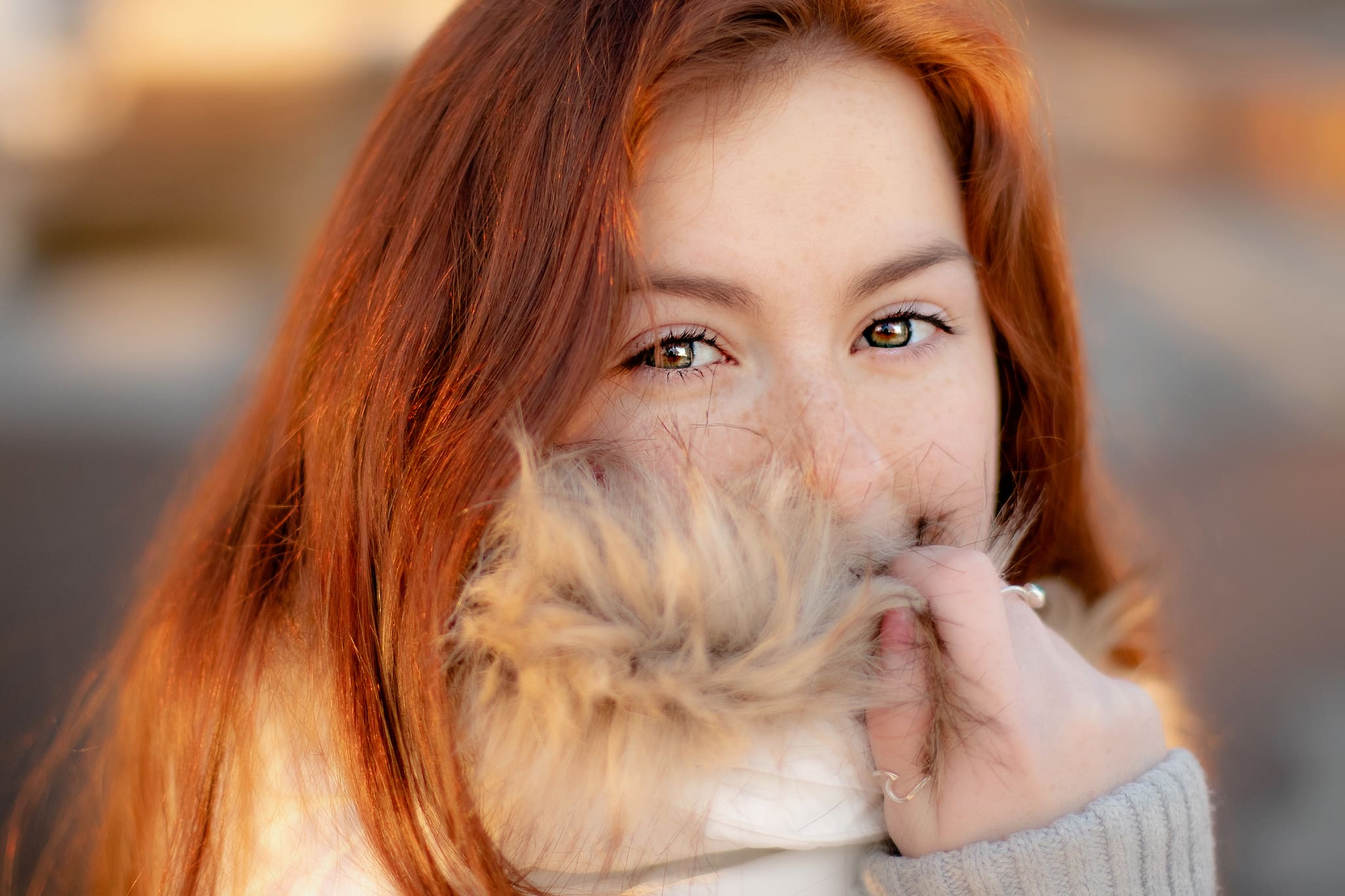 High school senior girl bundled up in her winter season coat for her senior photos.