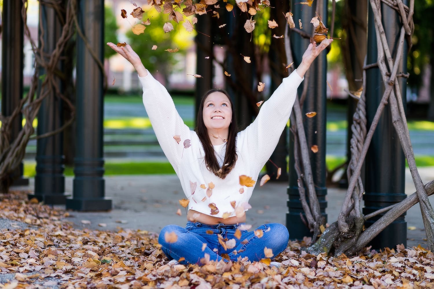Fall fun for this senior girl's photos session, throwing up the leaves in downtown.