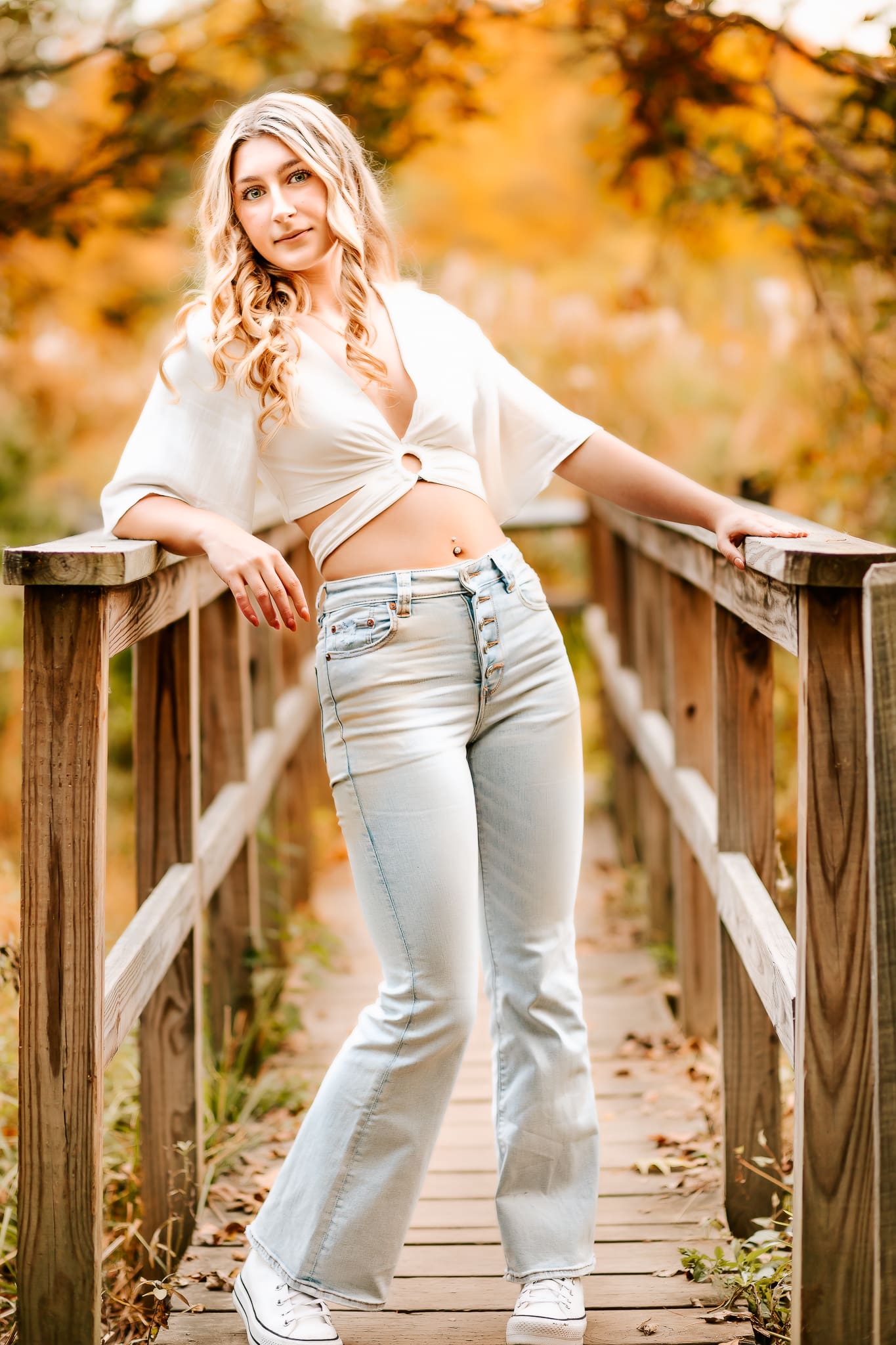 Senior Photo of a girl dressed in jeans and a white top for her yearbook photo.