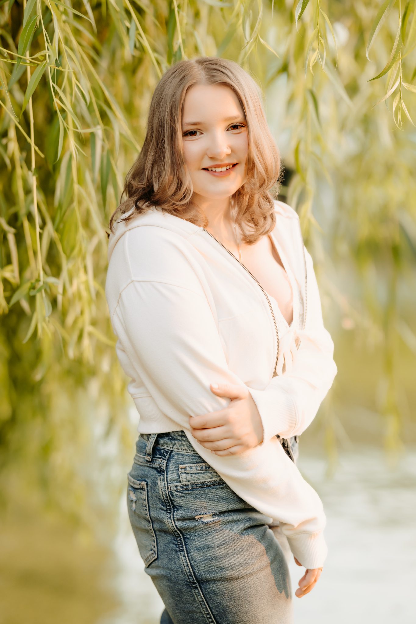 Senior girl standing in front of the weeping willows in the Boston Public Gardens, her perfect location for her senior photos.