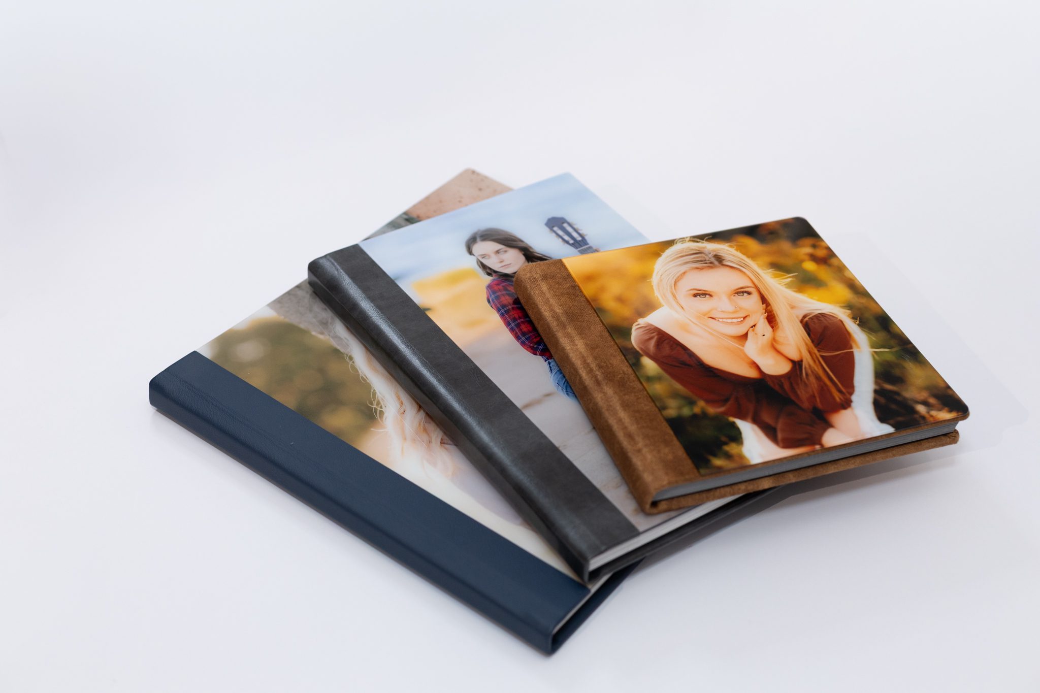 Stack of high school senior albums with image covers.