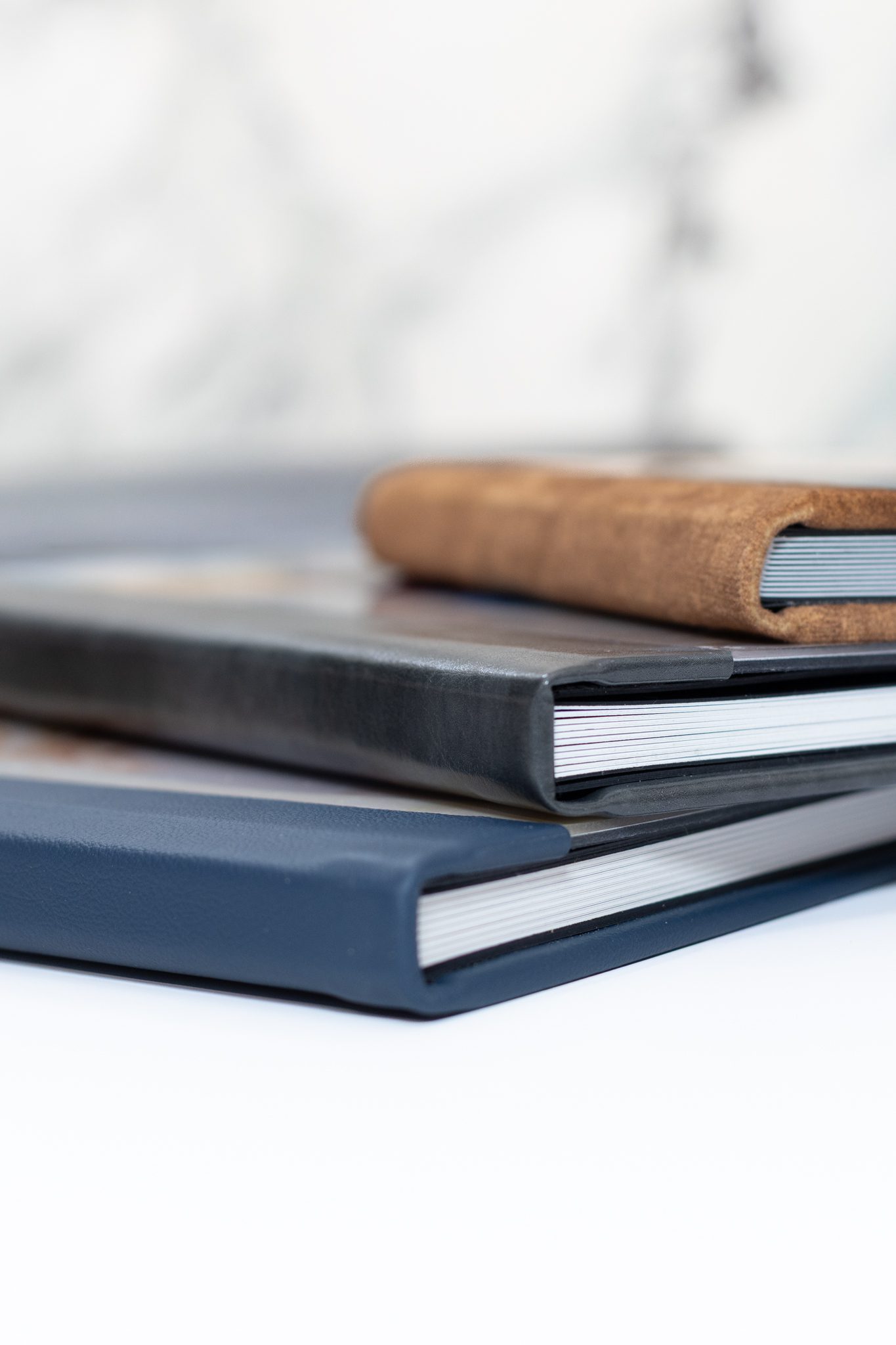 Side view of a stack of senior photo albums.