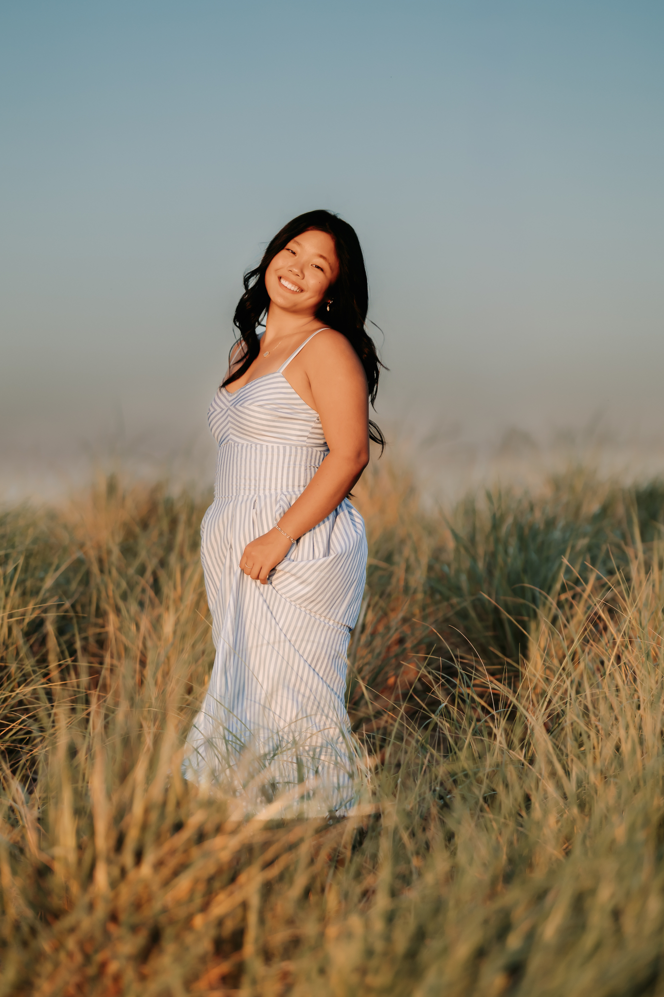 Senior high school girl swaying in her maxi dress for her photos in Newburyport, MA