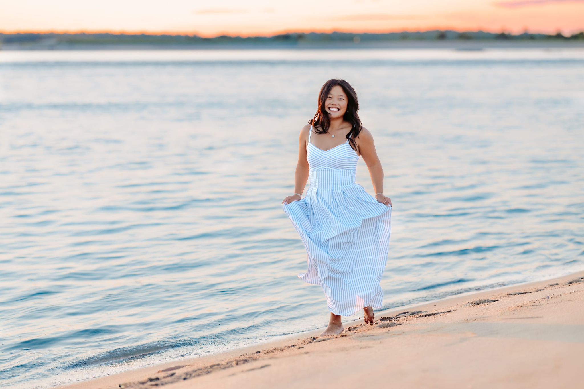 Senior Girl running along the shoreline at Plum Island Point, Newburyport, MA