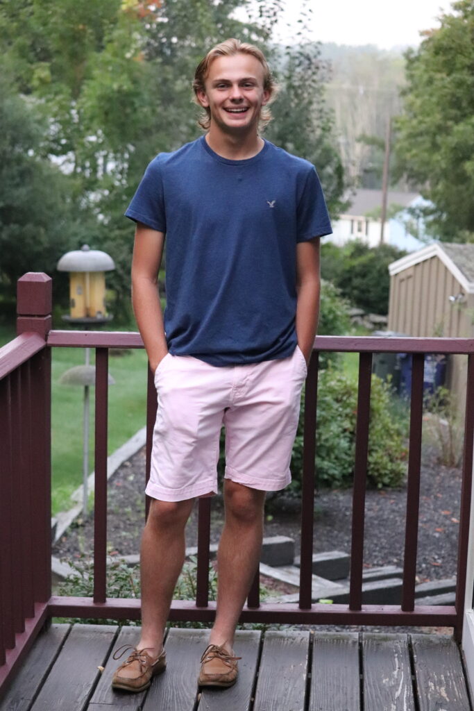 High school senior posing for his final first-day-of-school photo