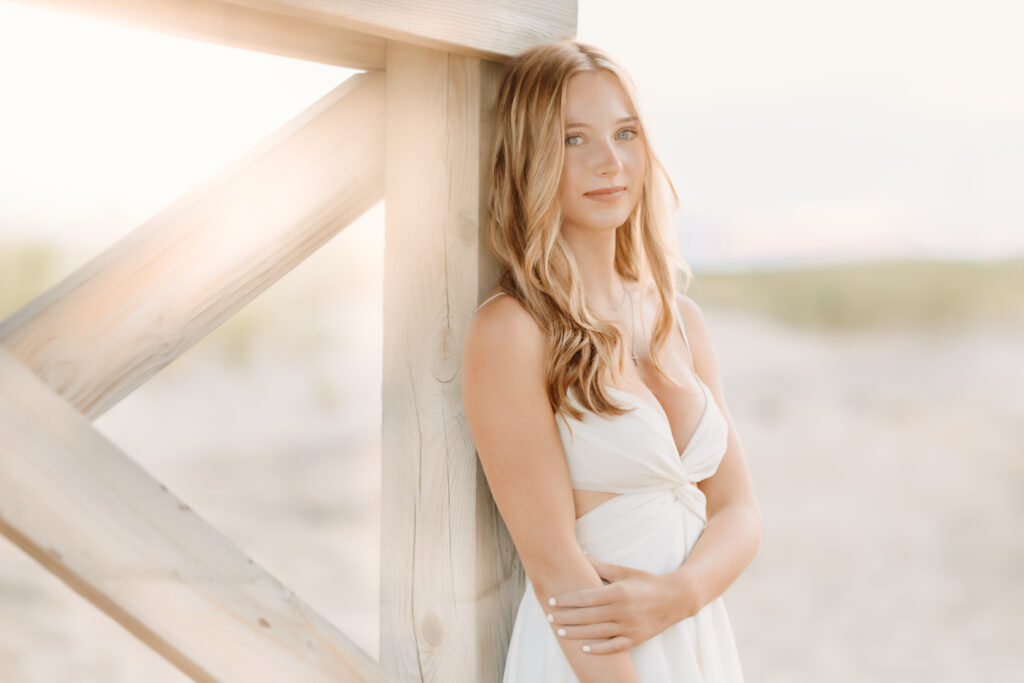 High school senior posing on the beach during her senior photo session in Massachusetts