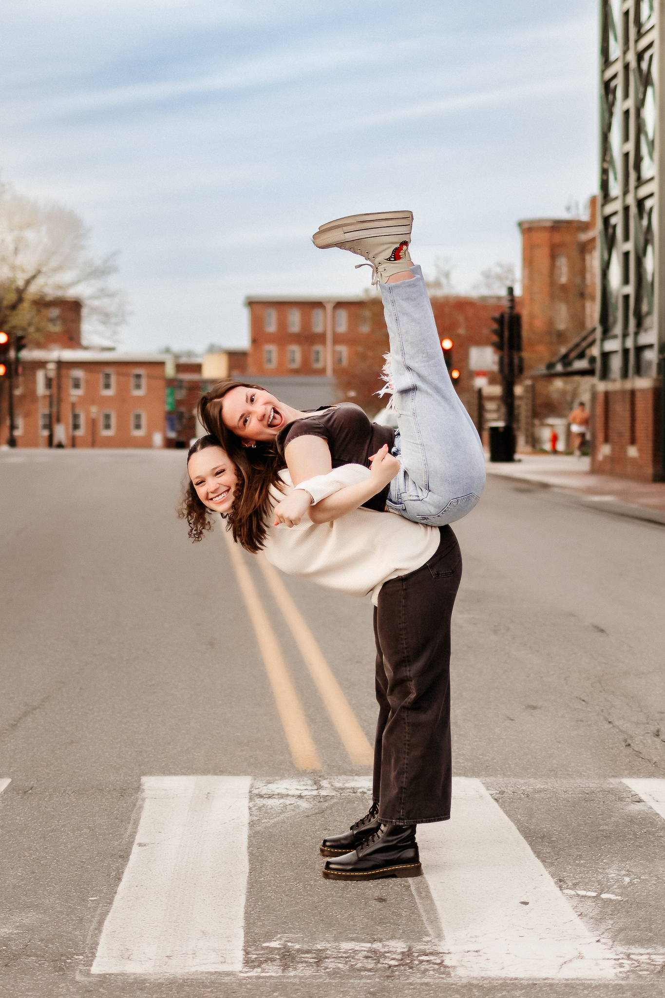 Two high school seniors laughing and having fun together during senior photos, Lowell, MA