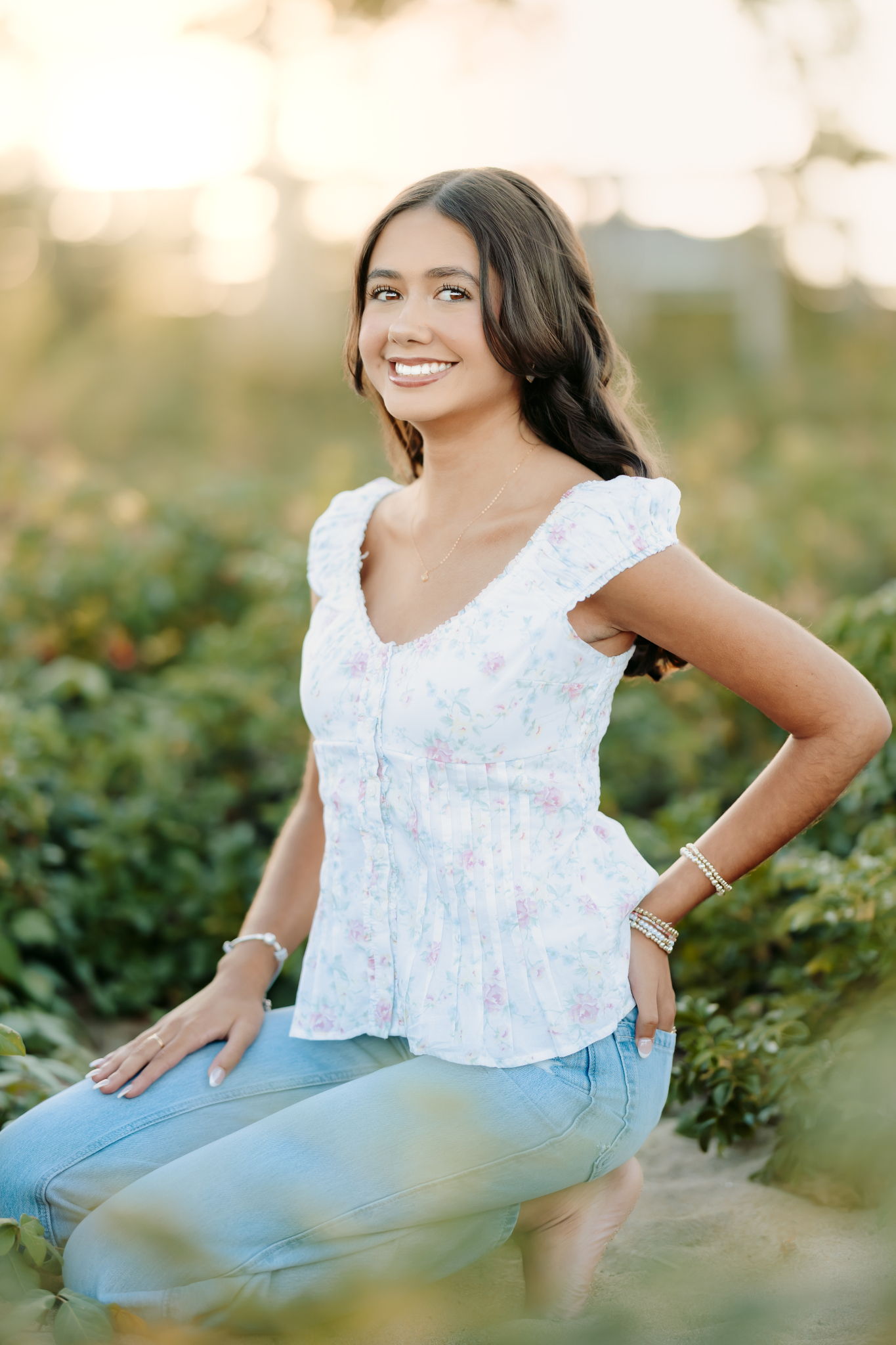 Massachusetts senior casually posing in the beach flowers in Newburyport, MA.