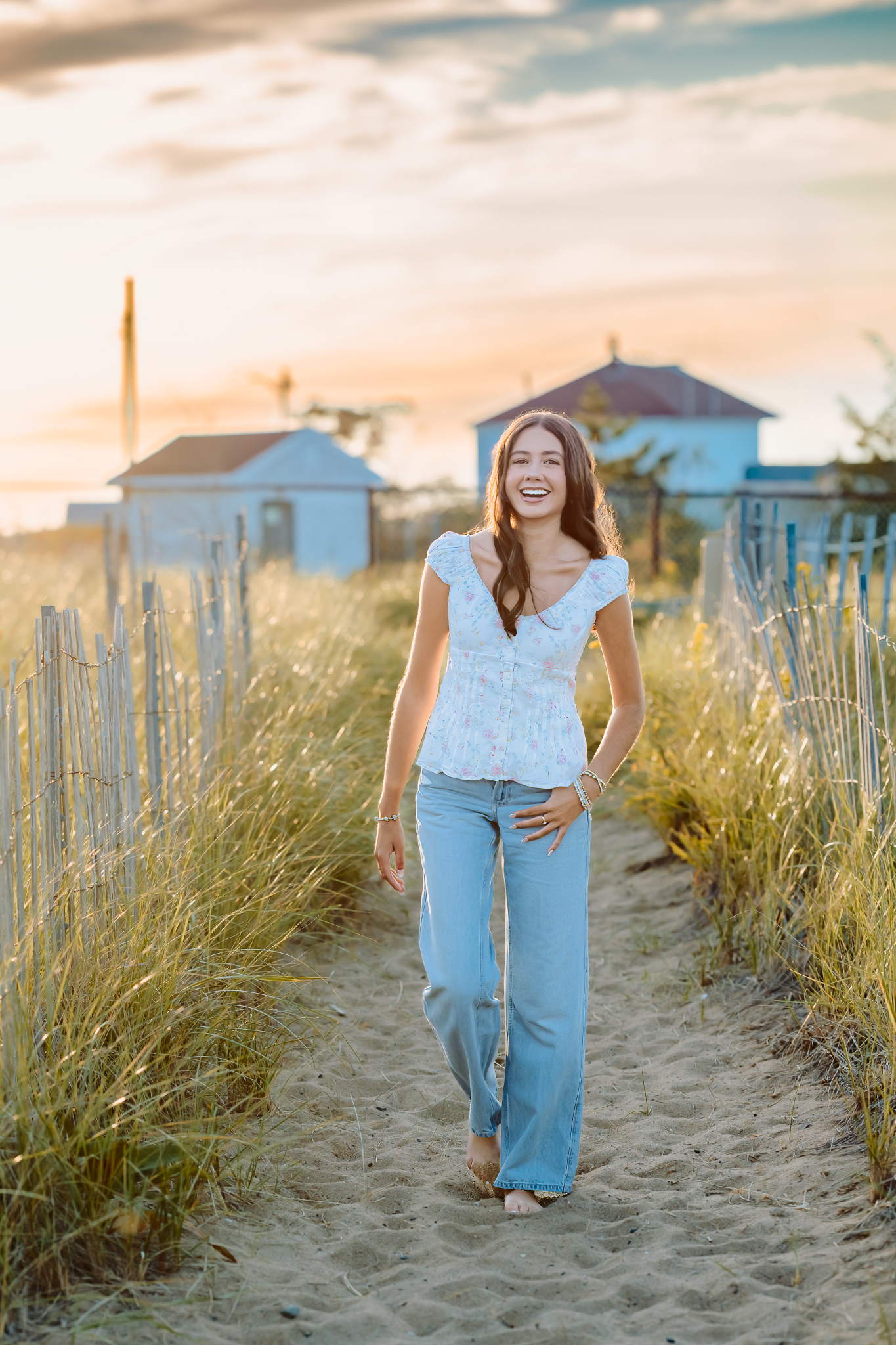 Senior girl walking along the beach path of the dunes during her senior photos session at Plum Island, Newburyport.